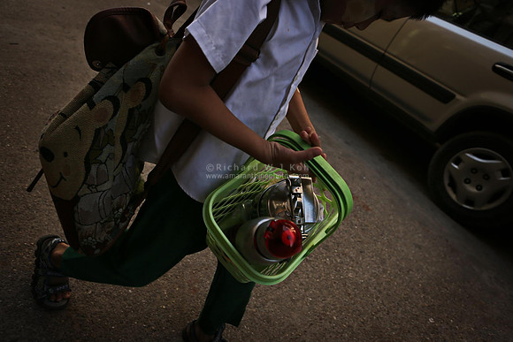 Yangon boy carrying food and drink canteens