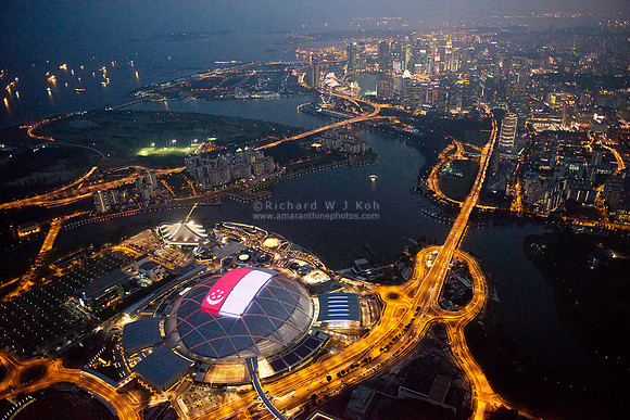 Singapore National Stadium (Sports Hub) night aerial photo with state flag LED panel display