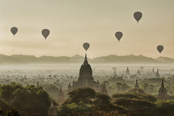 Bagan plains of pagodas at sunrise with hot air balloons